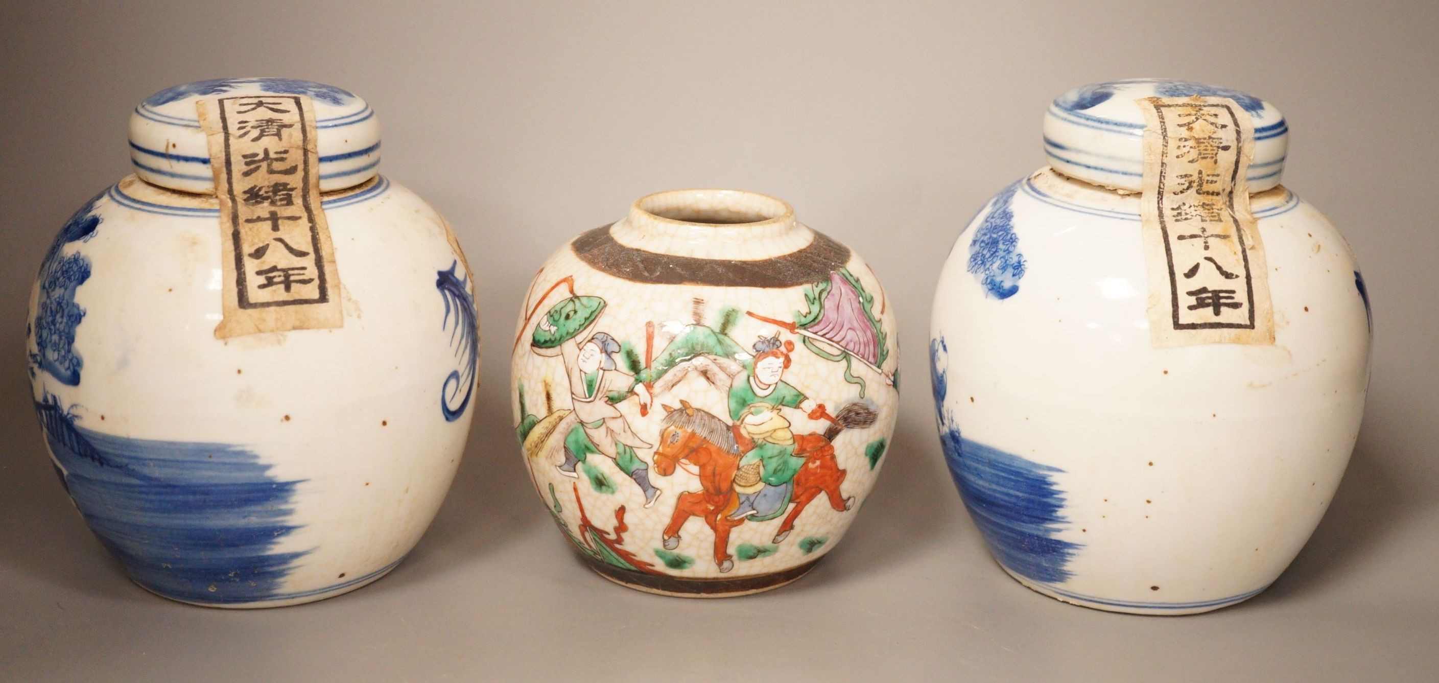 A Chinese crackleglaze famille rose jar and two blue and white jars, 16cm